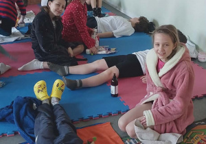 Uczniowie klasy trzeciej na świetlicy mają rozłożone ręczniki, dziewczynki są w szlafrokach obok leży olejek do masażu