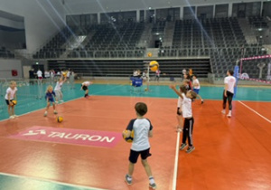 Hala Sport Arena, uczniowie trenują na boisku do siatkóki, przed meczem